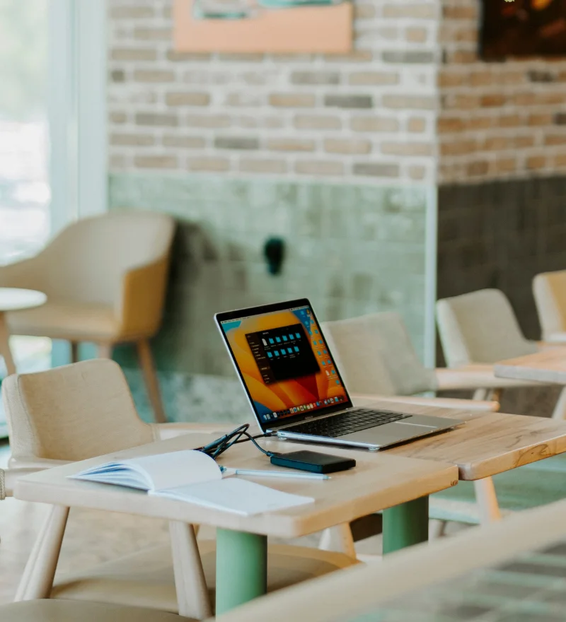 Geschäftsprozesse dokumentieren - Ein Laptop auf einem Tisch in einem CoWorking Space.